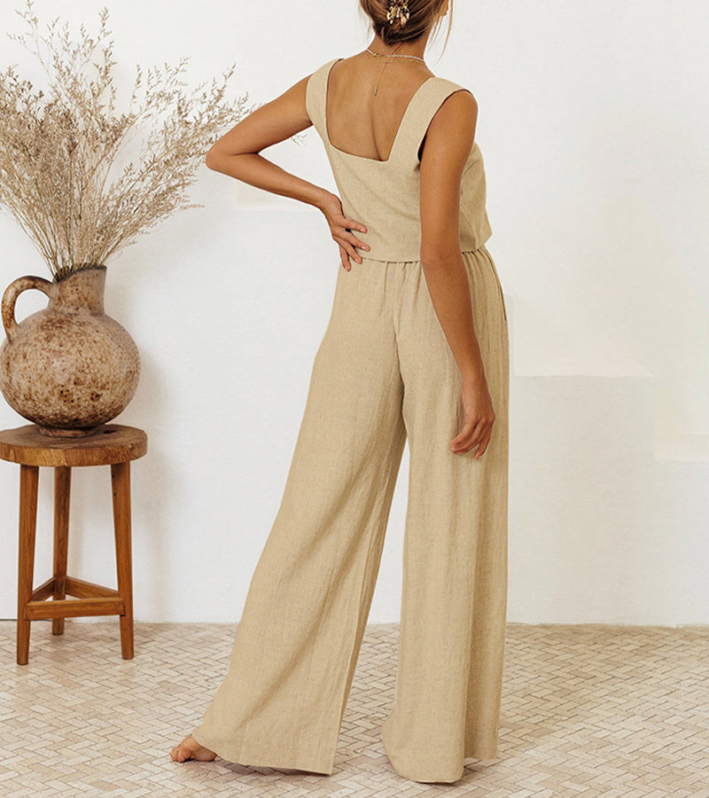 A woman wearing a minimal two-piece set with a square neckline and belted flared pants.