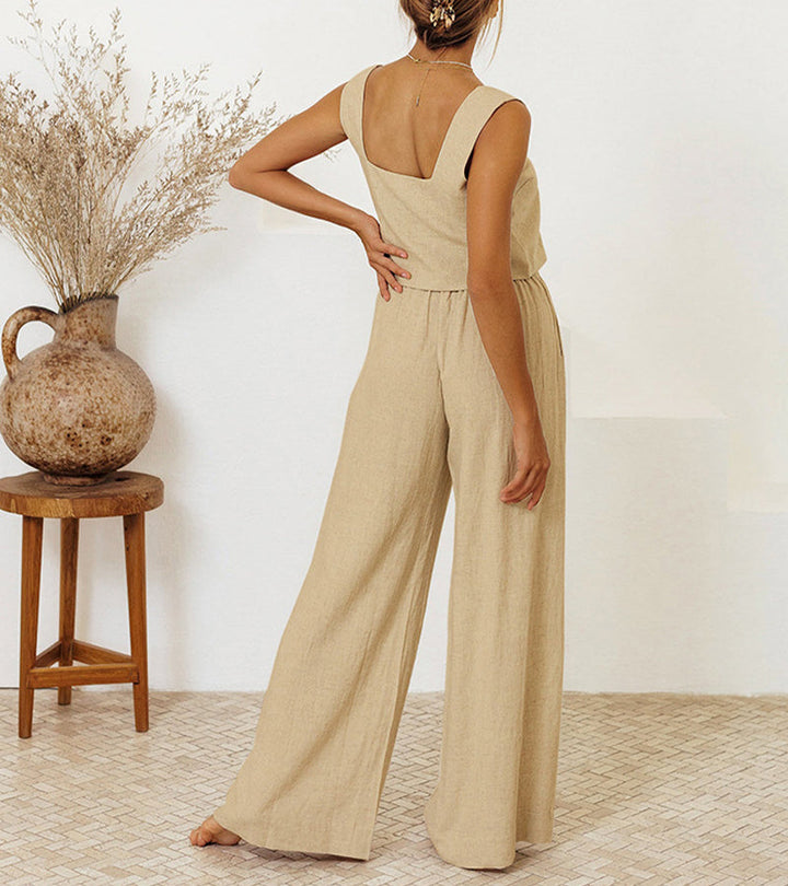 A woman wearing a minimal two-piece set with a square neckline and belted flared pants.
