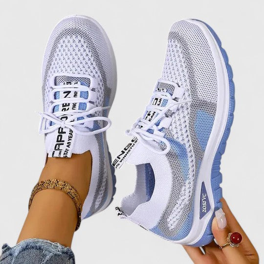 A woman lacing up light, breathable orthopaedic sneakers before a walk.
