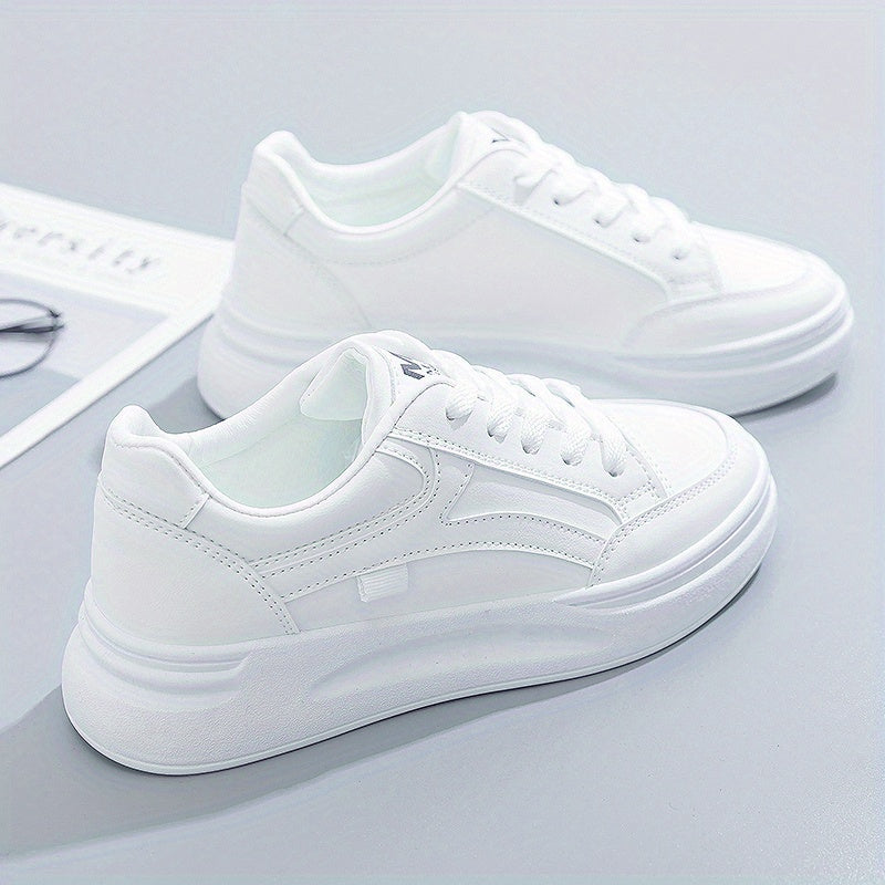 A woman in crisp white light comfort sneakers paired with jeans.