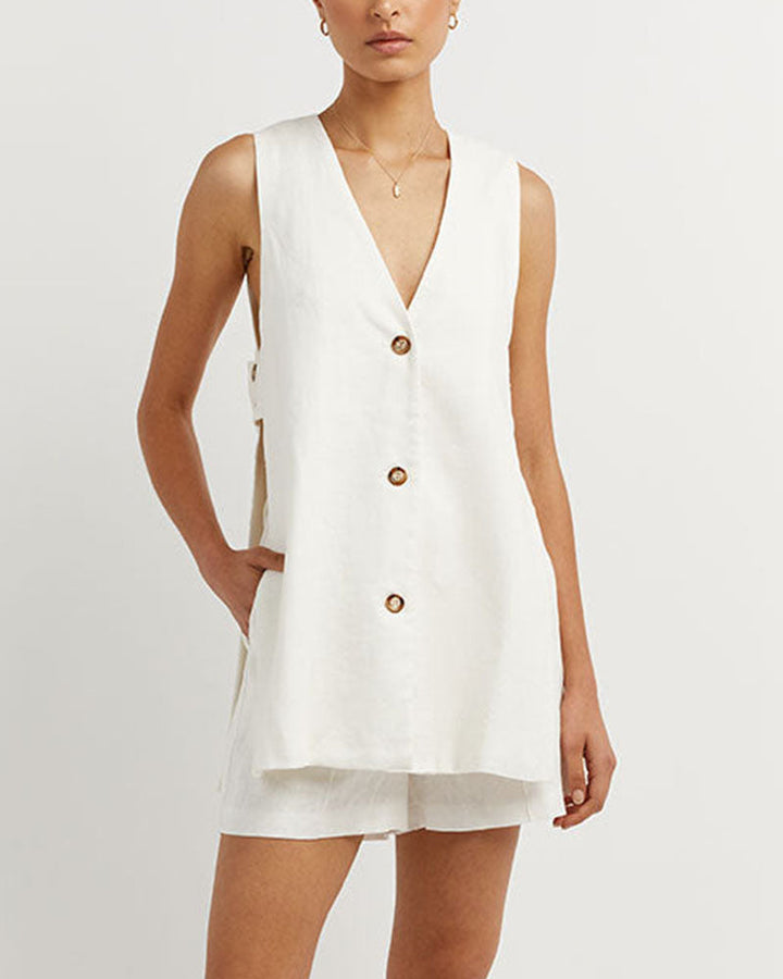 A woman wearing a sleeveless buttoned two-piece set