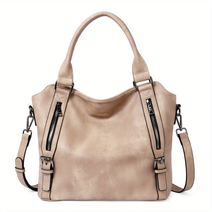 A woman wearing a roomy shoulder bag across her body while out running errands.