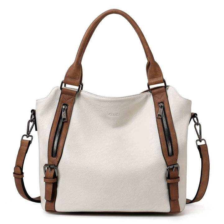 A woman wearing a roomy shoulder bag across her body while out running errands.