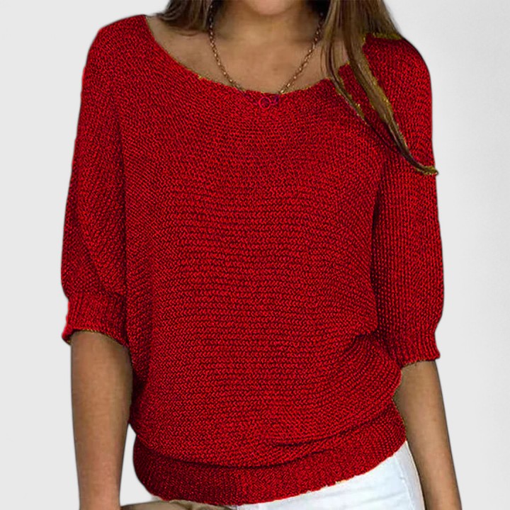 A woman wearing a soft purple sweater with a wide neckline and gently shaped fit.