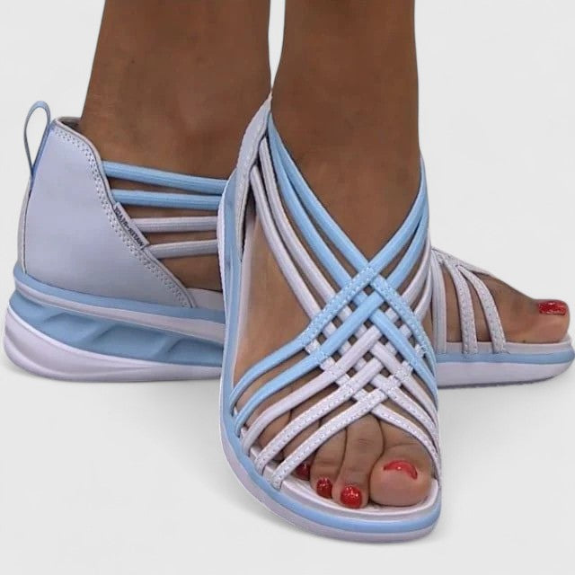 A woman walking comfortably in wide-fit multi-strap orthopaedic sandals with an open design.