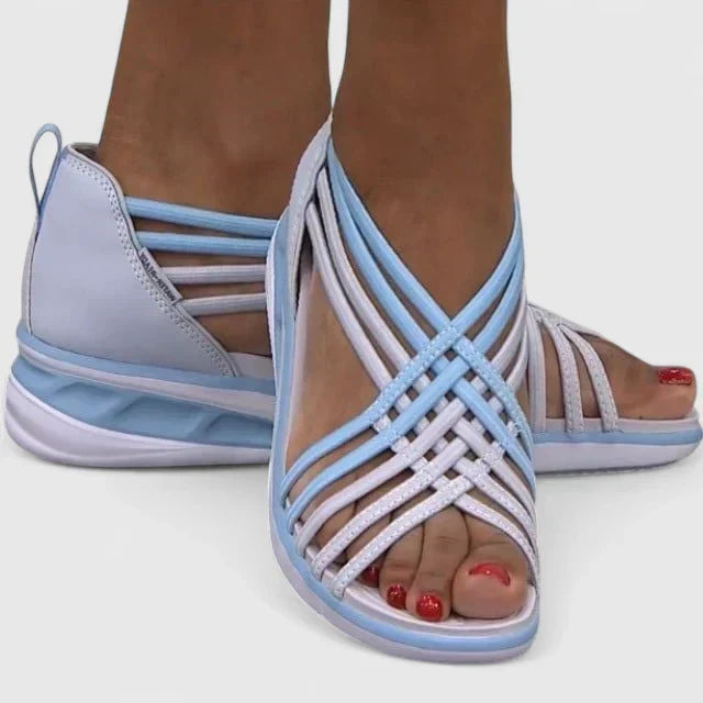A woman walking with ease in elegant wide-fit everyday sandals with a cushioned footbed.