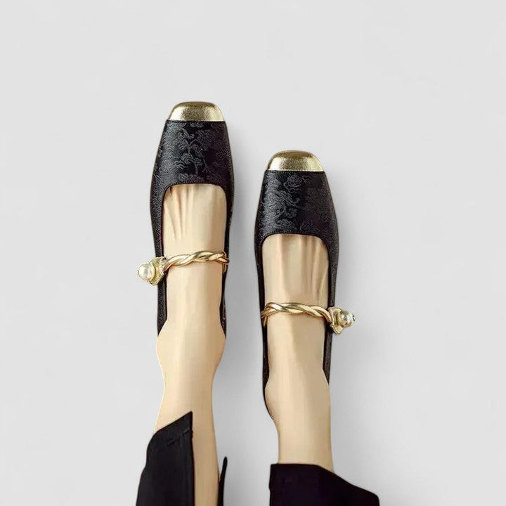 A woman in sparkling Mary Jane shoes with a low block heel at an evening celebration.