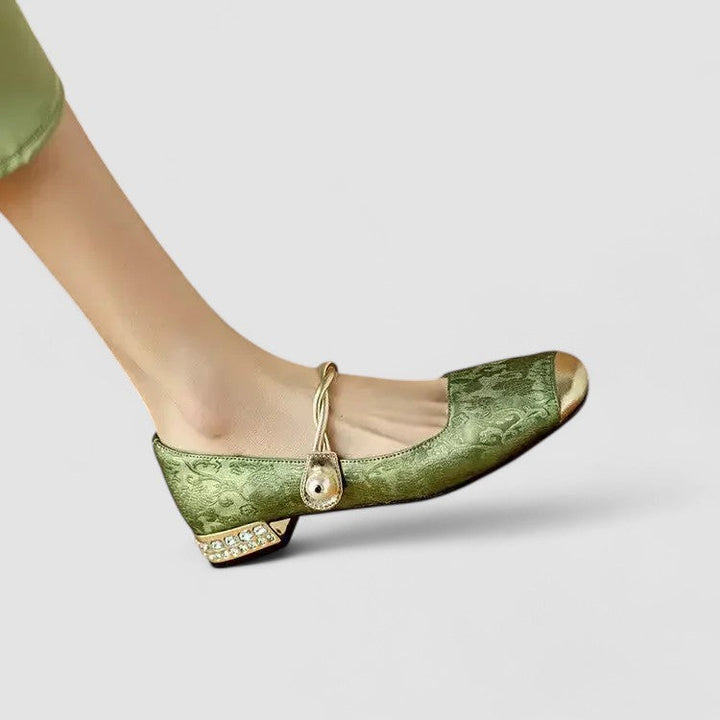 A woman in sparkling Mary Jane shoes with a low block heel at an evening celebration.