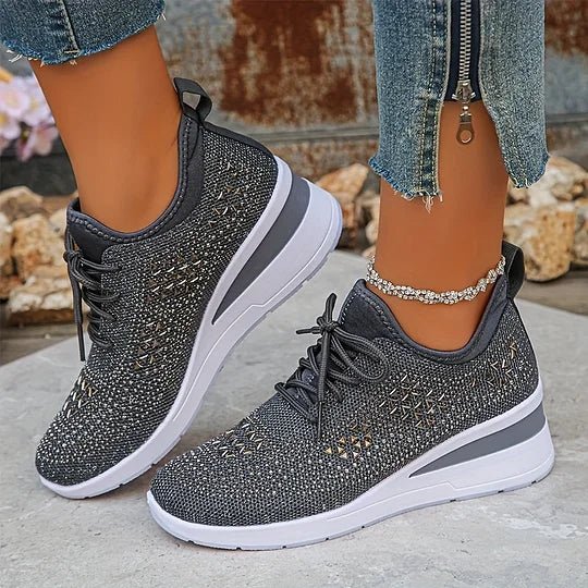 A woman walking comfortably outdoors in supportive everyday shoes.