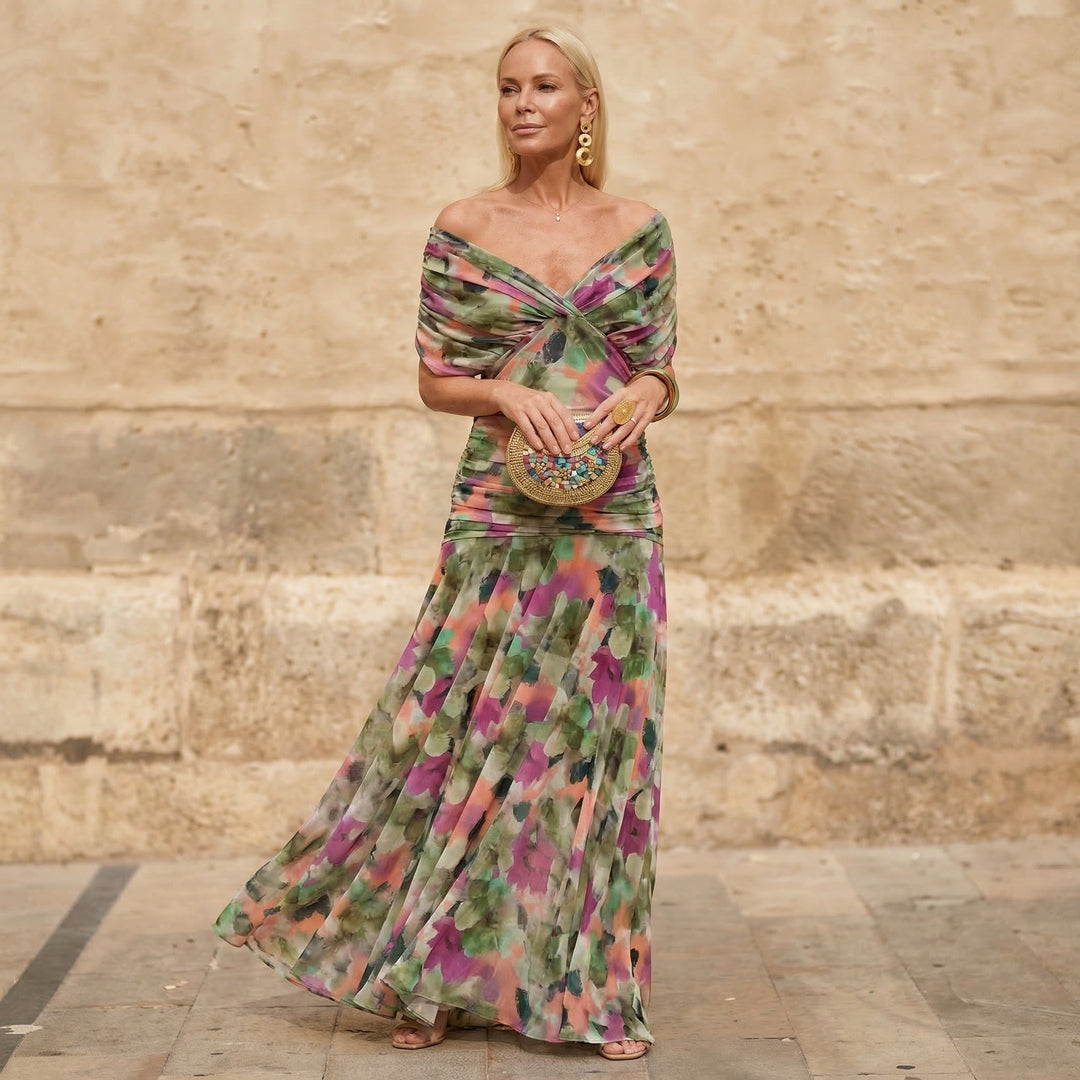 A woman wearing an elegant flowing multicolour dress at a celebration.