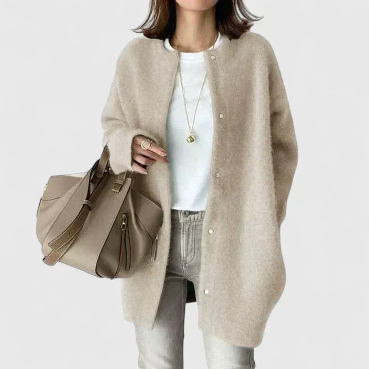 A woman wearing a buttoned comfort jacket over a top