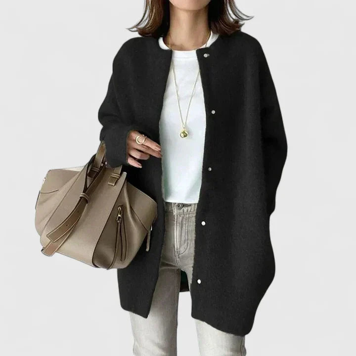 A woman wearing a buttoned comfort jacket over a top