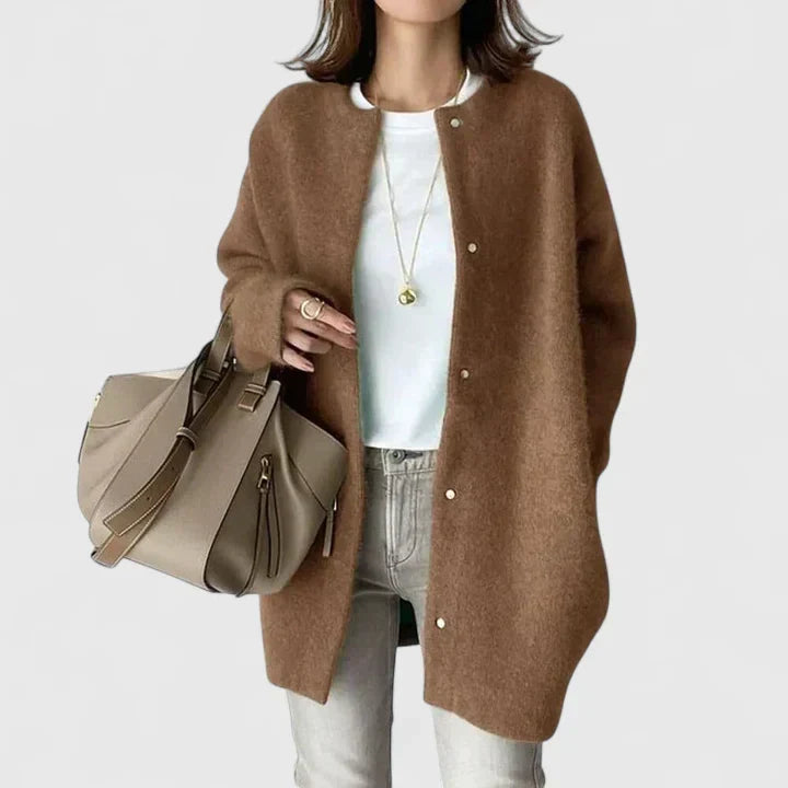 A woman wearing a buttoned comfort jacket over a top