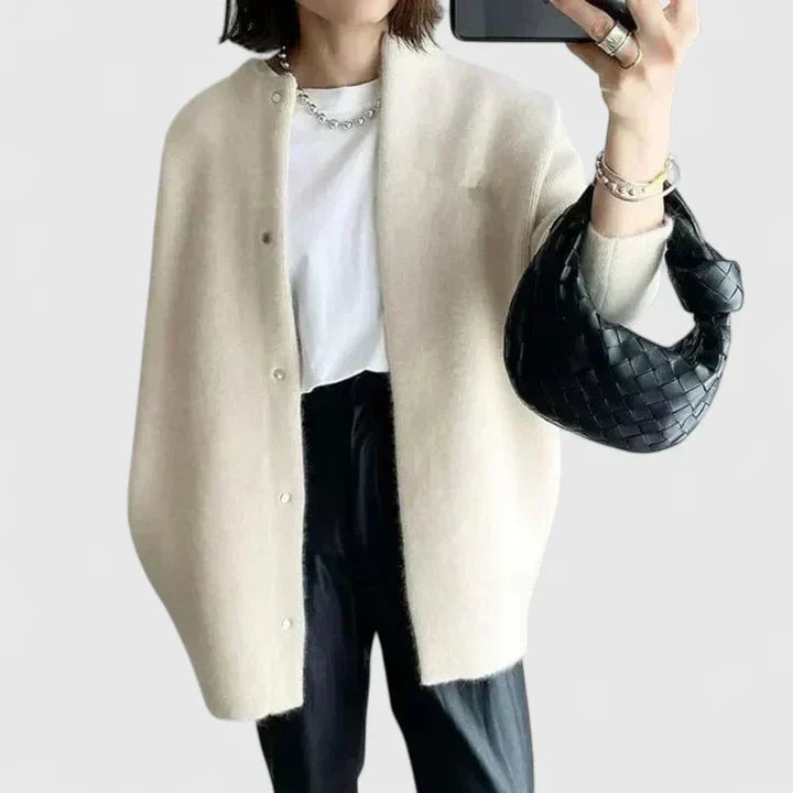 A woman wearing a buttoned comfort jacket over a top