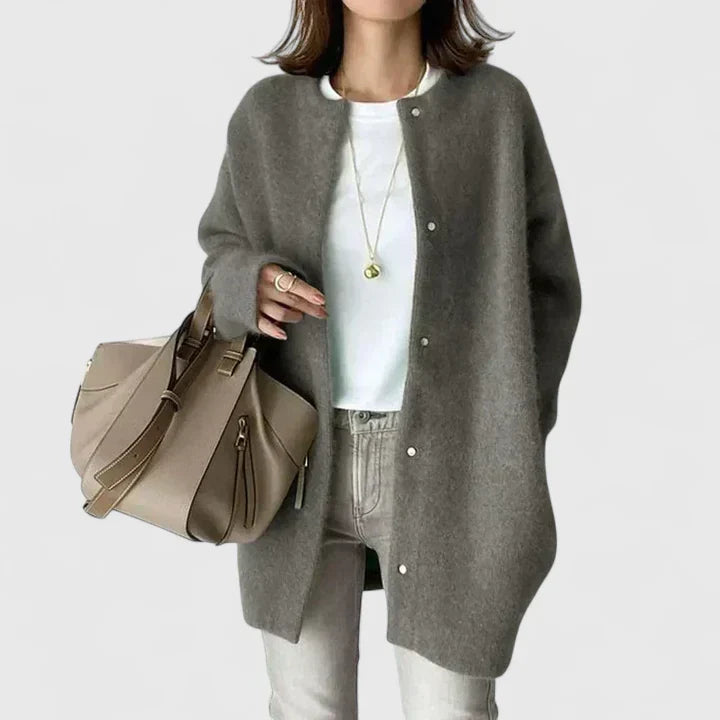 A woman wearing a buttoned comfort jacket over a top