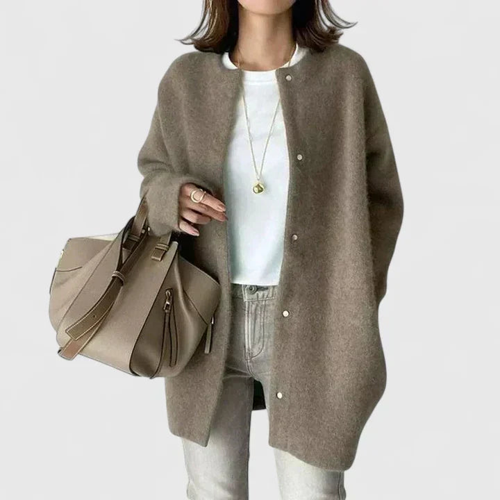 A woman wearing a buttoned comfort jacket over a top