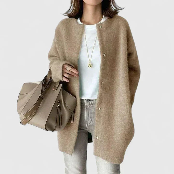 A woman wearing a buttoned comfort jacket over a top