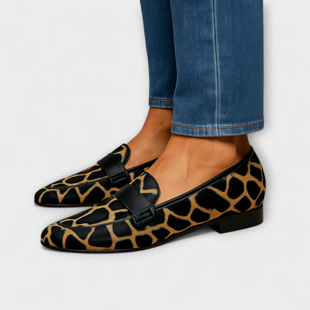 A woman wearing leopard-print loafers with a simple, elegant outfit