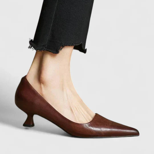 A woman in balanced comfort heels moving from the office to an evening reception.