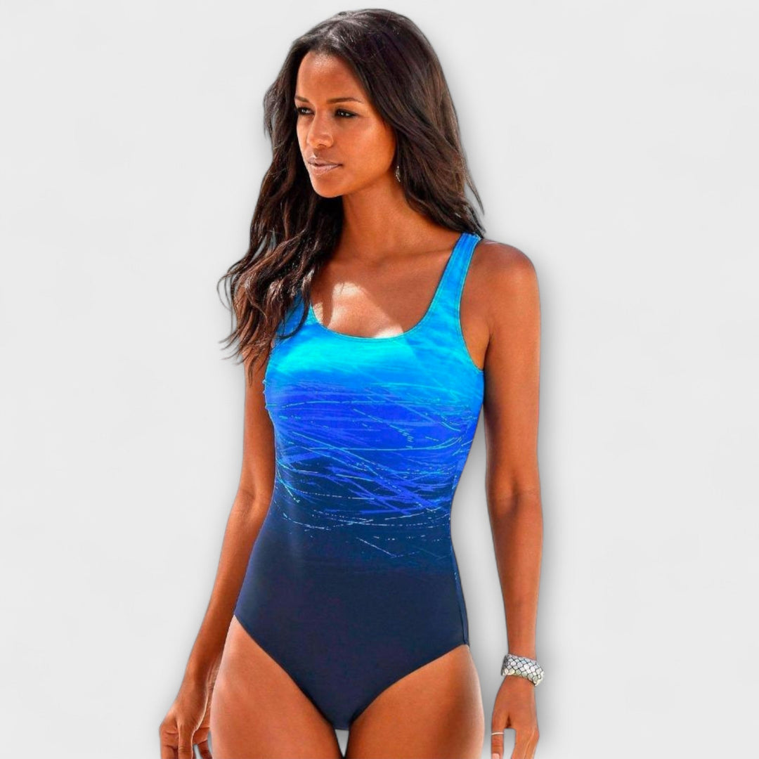 A woman at the pool in a sporty one-piece swimsuit, active and confident in the sunshine.