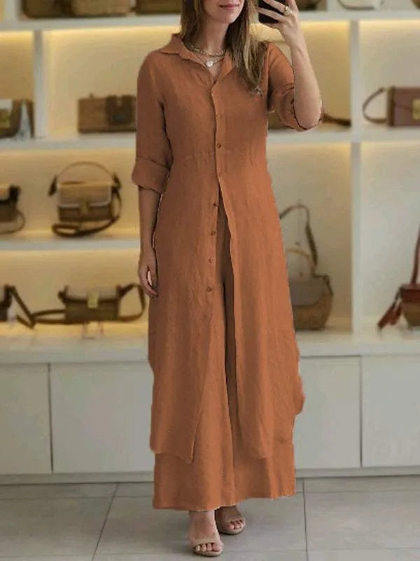 A woman wearing an elegant dress layered with flowing wide-leg pants.
