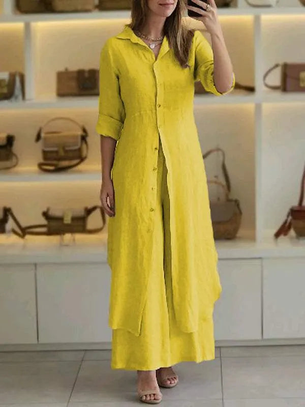 A woman wearing an elegant dress layered with flowing wide-leg pants.