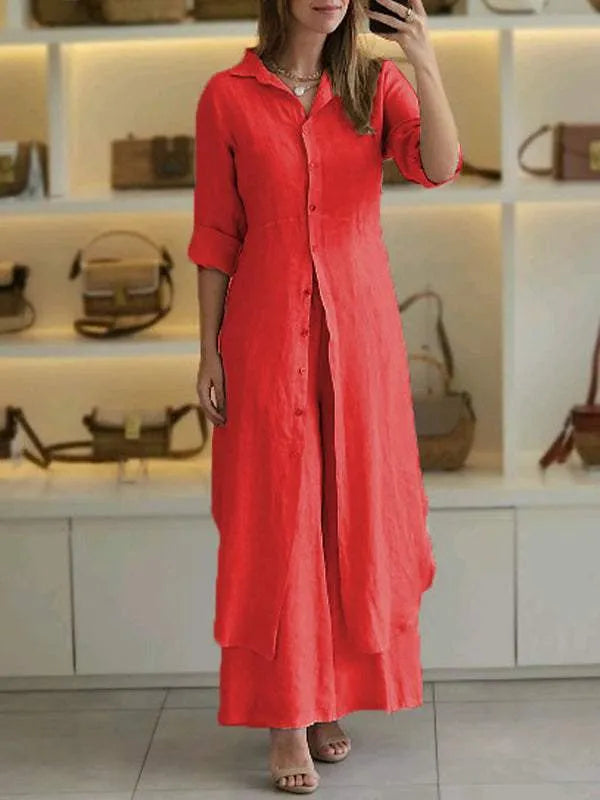 A woman wearing an elegant dress layered with flowing wide-leg pants.