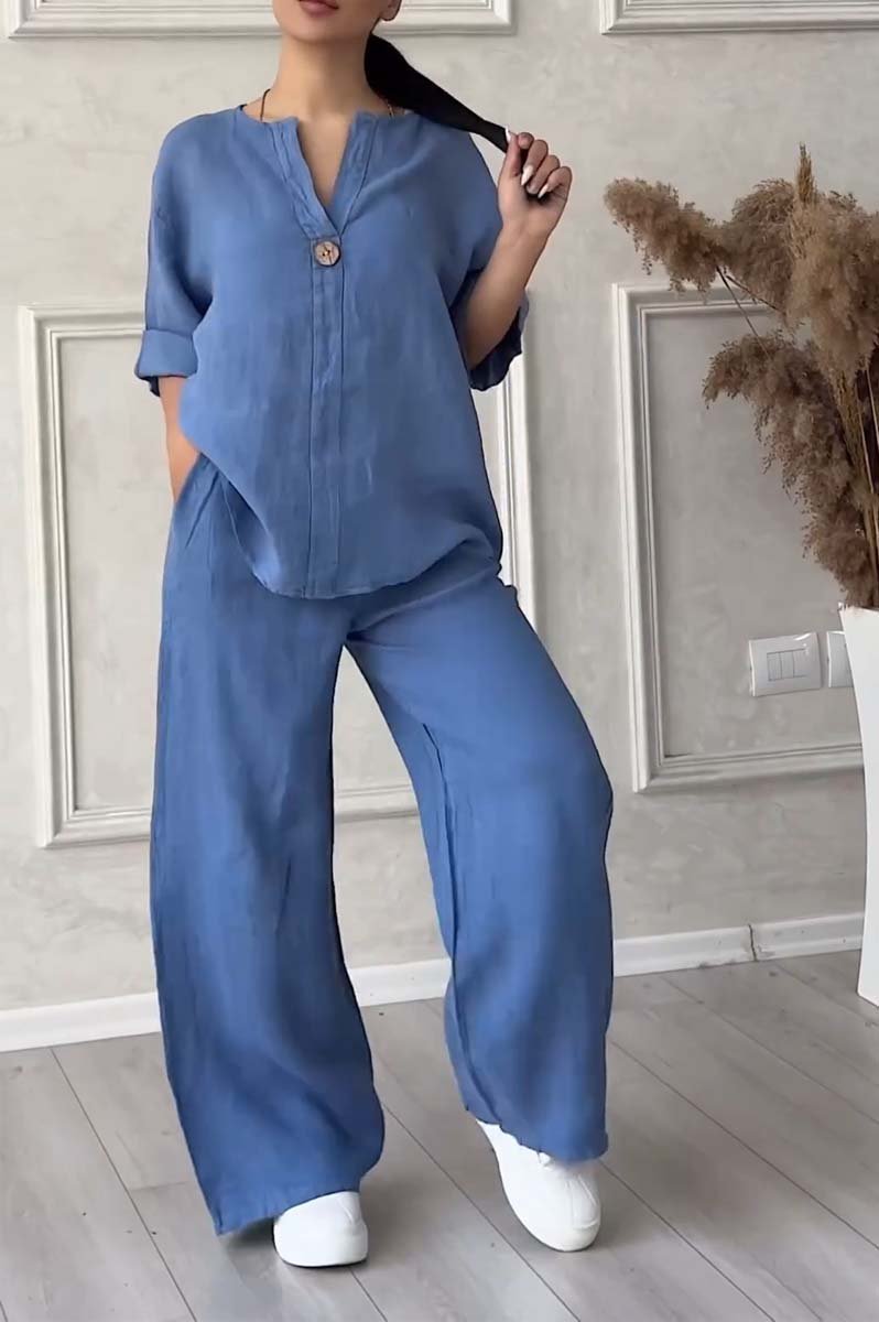A woman wearing a loose relaxed top with matching wide-cut pants.