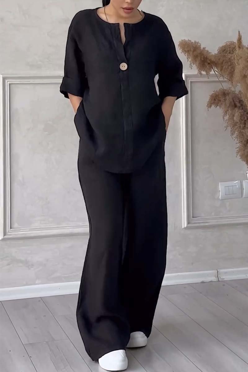 A woman wearing a loose relaxed top with matching wide-cut pants.