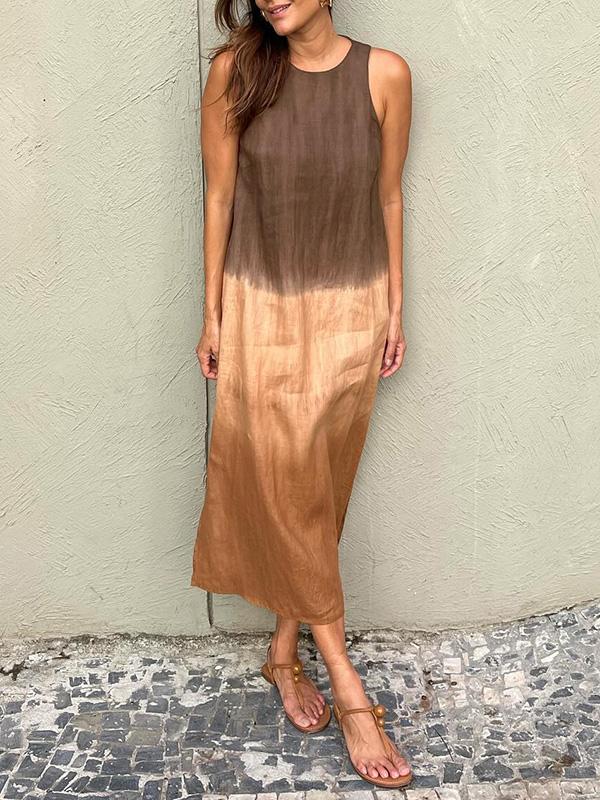 A woman wearing a sleeveless midi dress with a soft ombré colour gradient, walking outdoors.