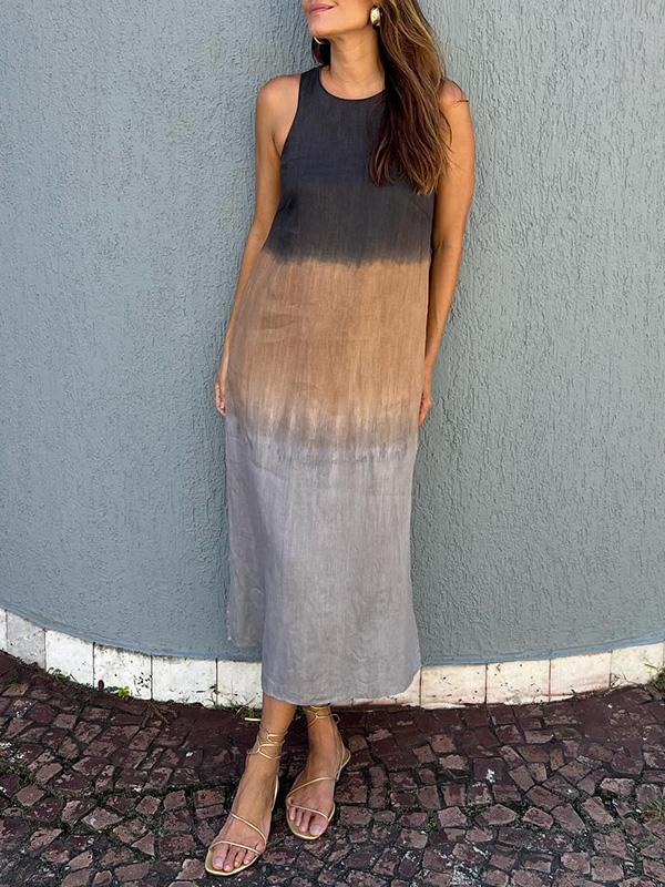 A woman wearing a sleeveless midi dress with a soft ombré colour gradient, walking outdoors.
