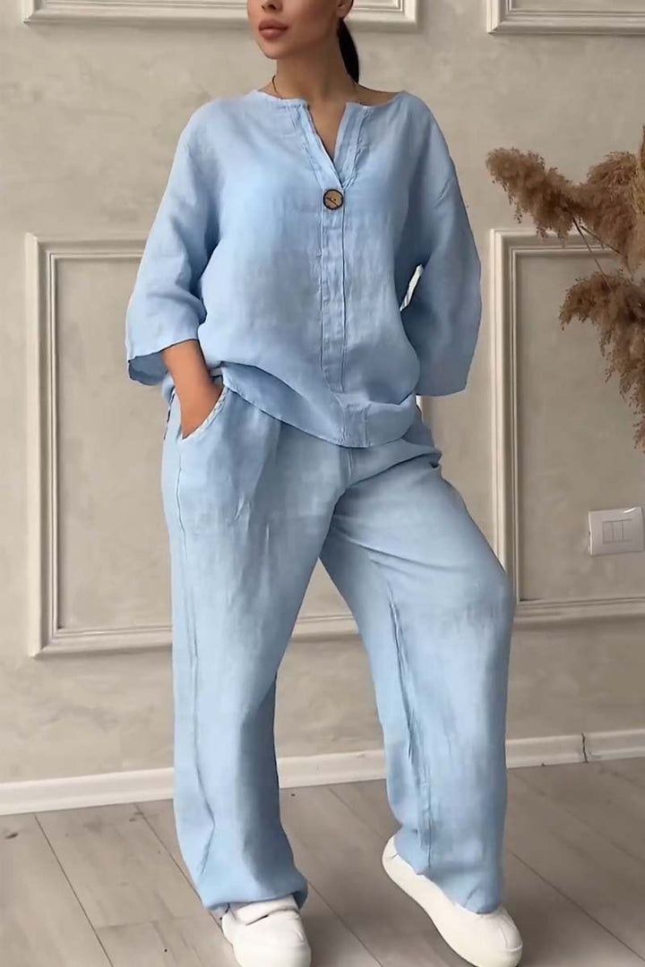A woman wearing a loose relaxed top with matching wide-cut pants.