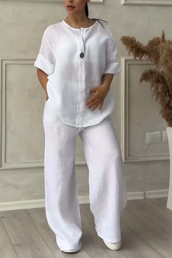 A woman wearing a loose relaxed top with matching wide-cut pants.