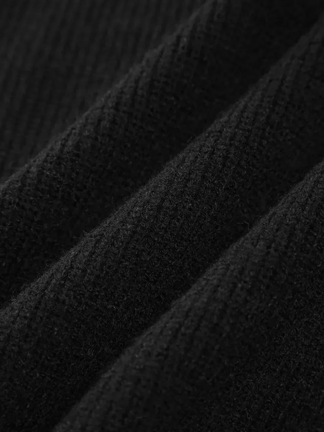 A woman wearing an oversized mock-neck sweater with whipstitch detailing, cosy and stylish.