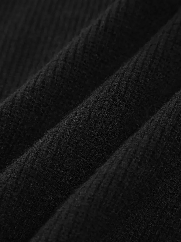 A woman wearing an oversized mock-neck sweater with whipstitch detailing, cosy and stylish.