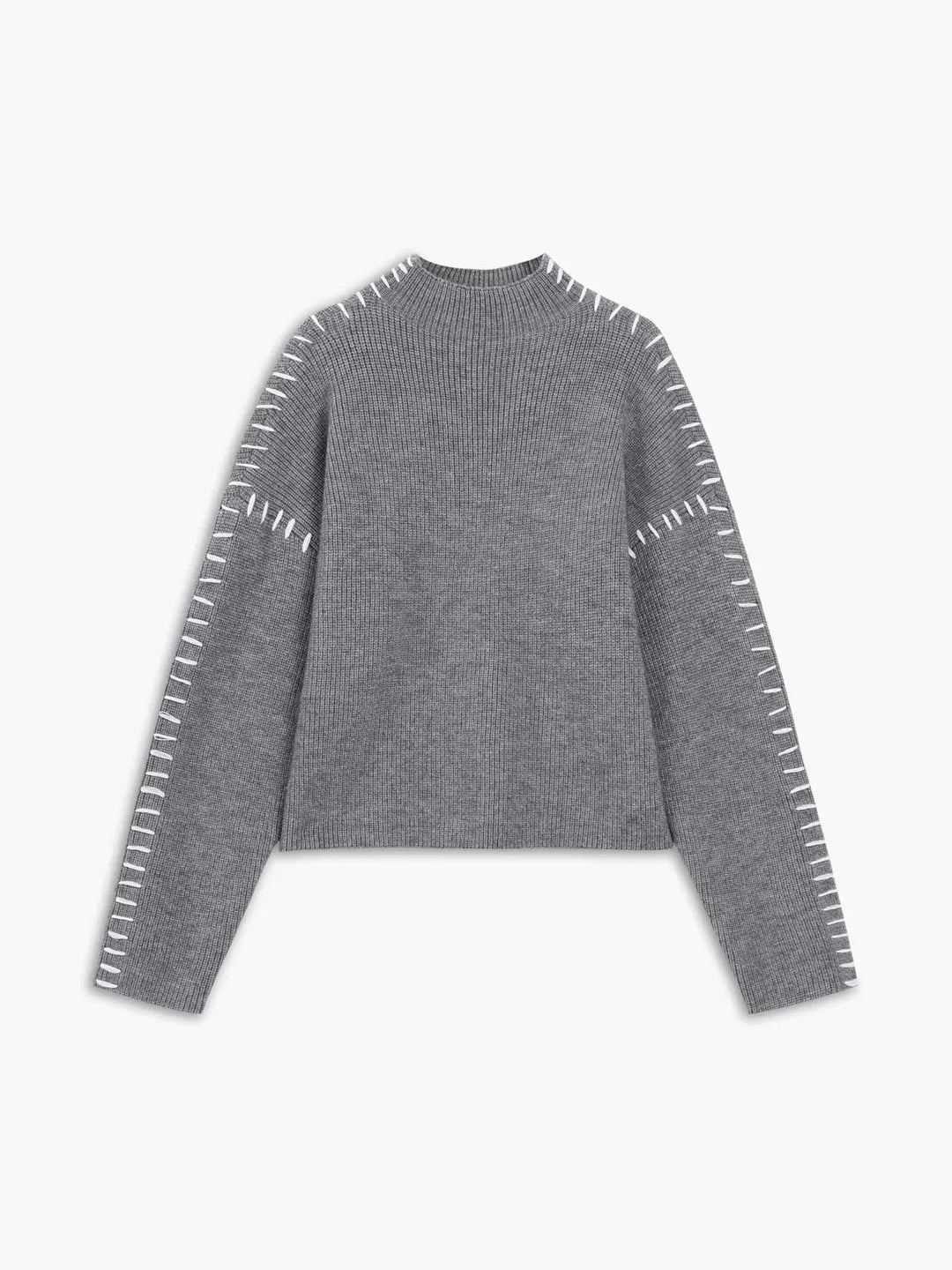 A woman wearing an oversized mock-neck sweater with whipstitch detailing, cosy and stylish.