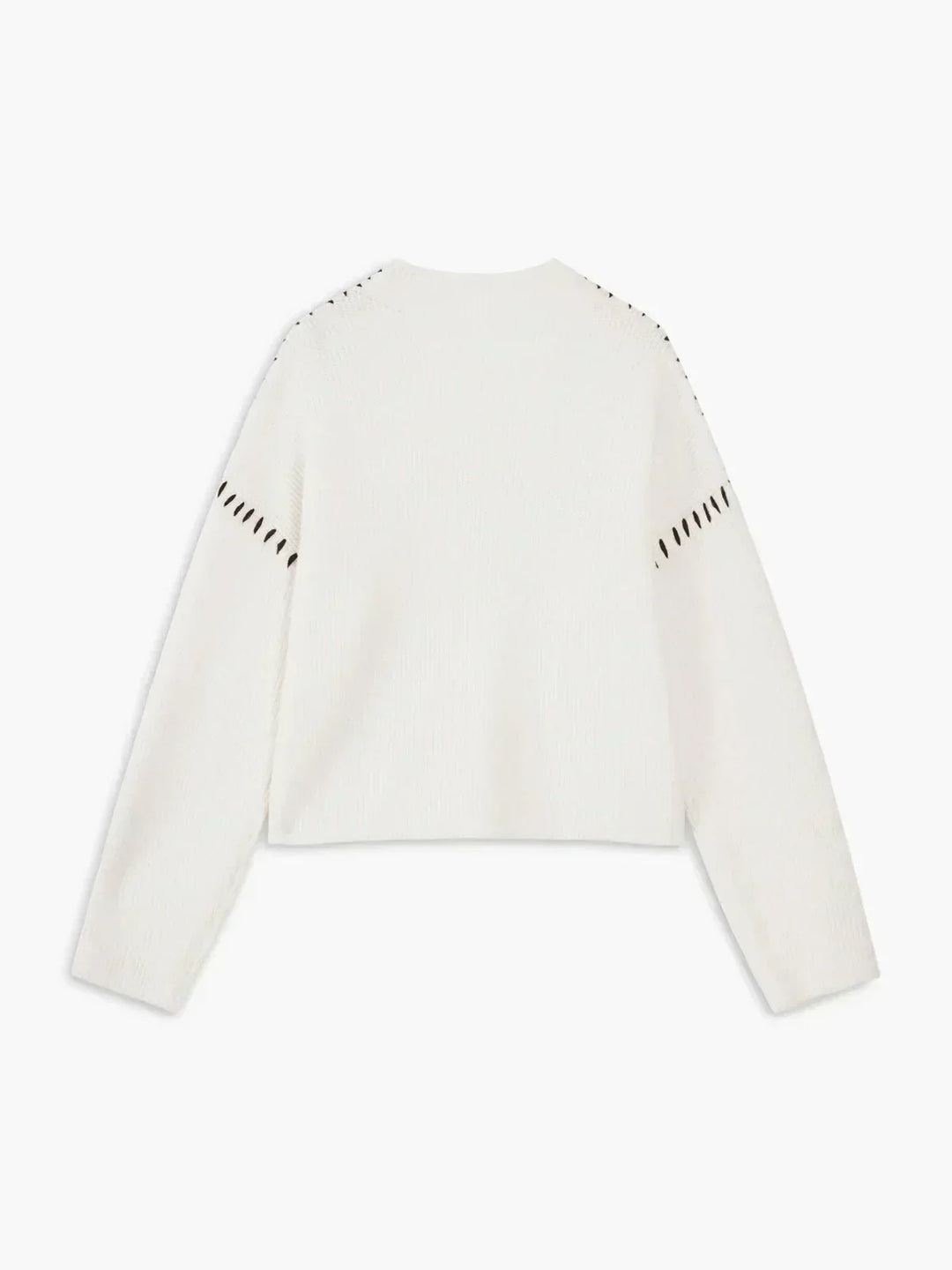 A woman wearing an oversized mock-neck sweater with whipstitch detailing, cosy and stylish.