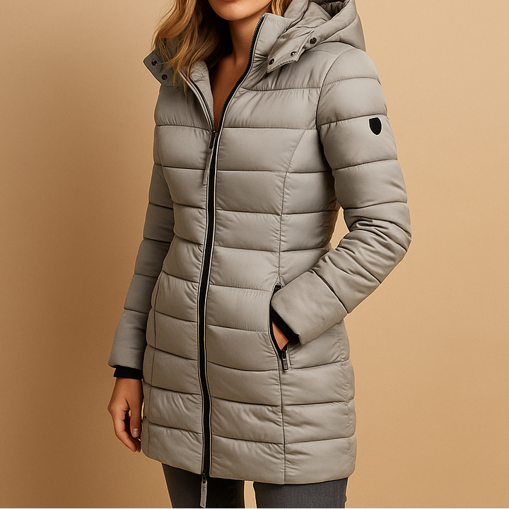 A woman wearing a longline black hooded puffer jacket with zip side pockets