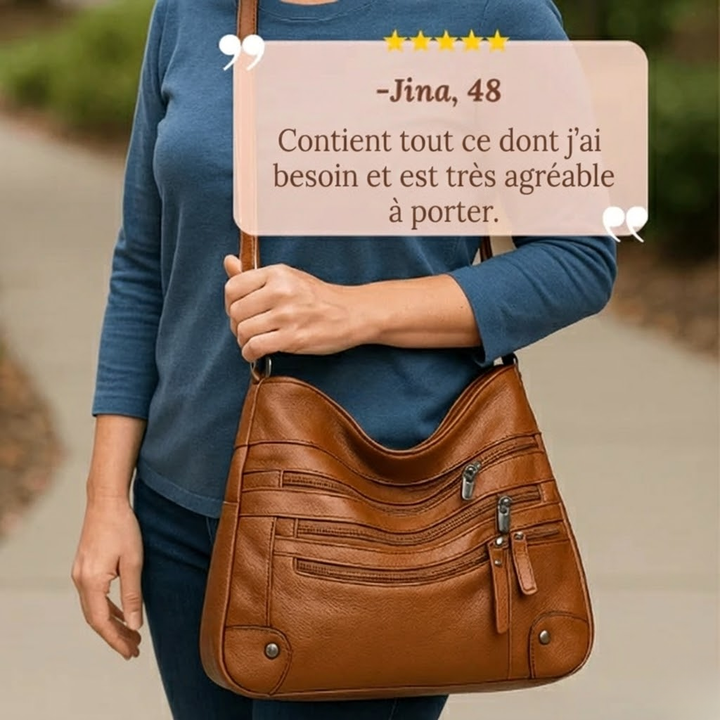 A woman wearing a soft elegant crossbody bag across her body while out shopping.