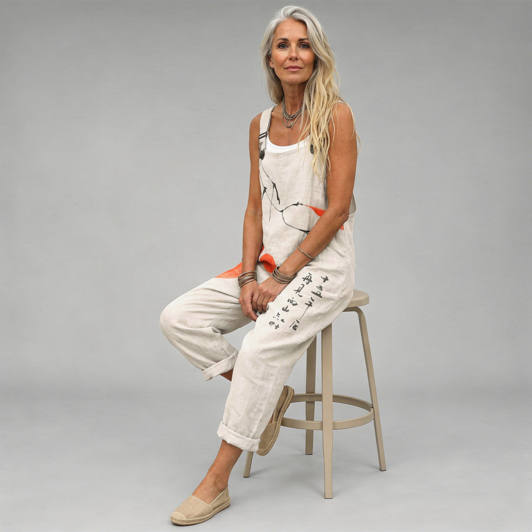 Woman wearing cream overalls printed with black ink brushstrokes and orange painted circles.