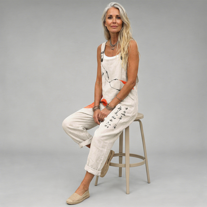 Woman wearing cream overalls printed with black ink brushstrokes and orange painted circles.