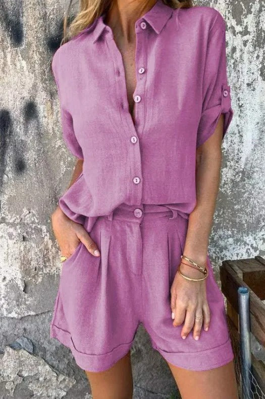 A woman in a coordinated button top and shorts set, styled for an easy sunny summer look.