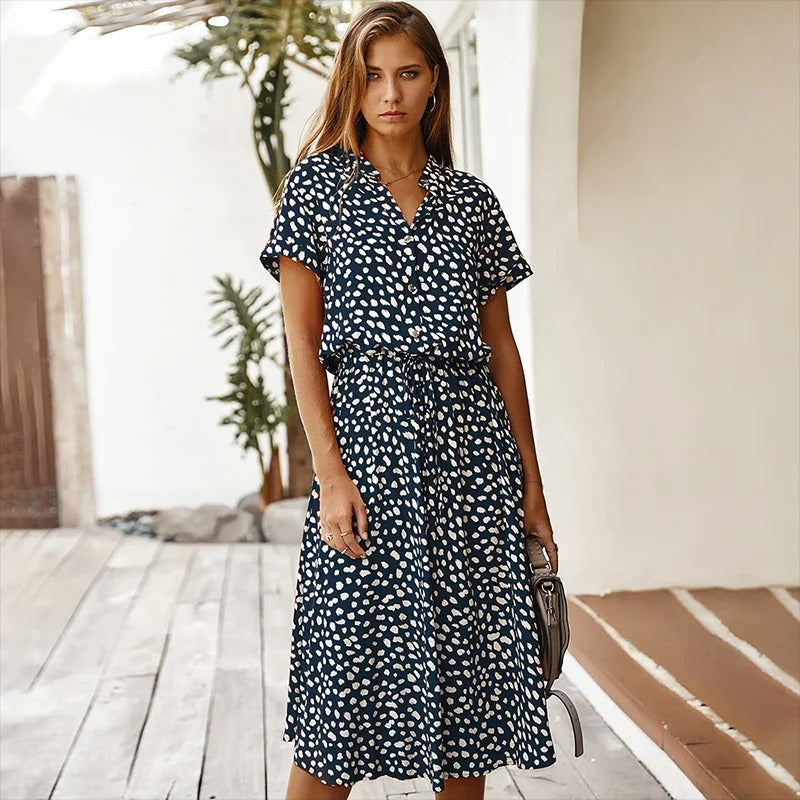Woman wearing the Alicia™ printed summer midi dress with a flowing skirt, out for a bright summer stroll.