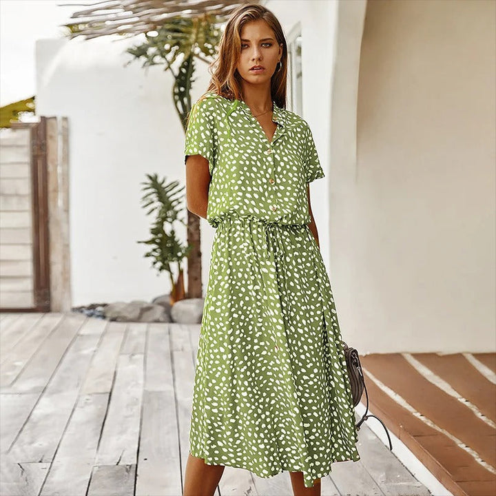 Woman wearing the Alicia™ printed summer midi dress with a flowing skirt, out for a bright summer stroll.