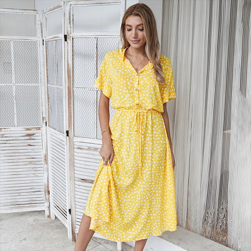 Woman wearing the Alicia™ printed summer midi dress with a flowing skirt, out for a bright summer stroll.