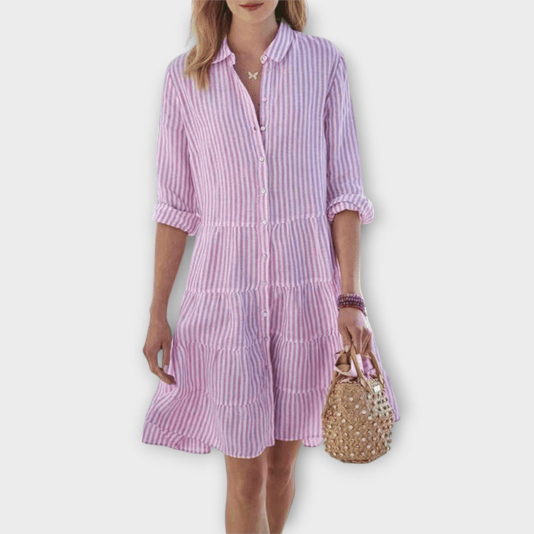 Woman wearing the Renee™ striped button-through shirt dress with roll-up sleeves, walking outdoors in the sunshine.