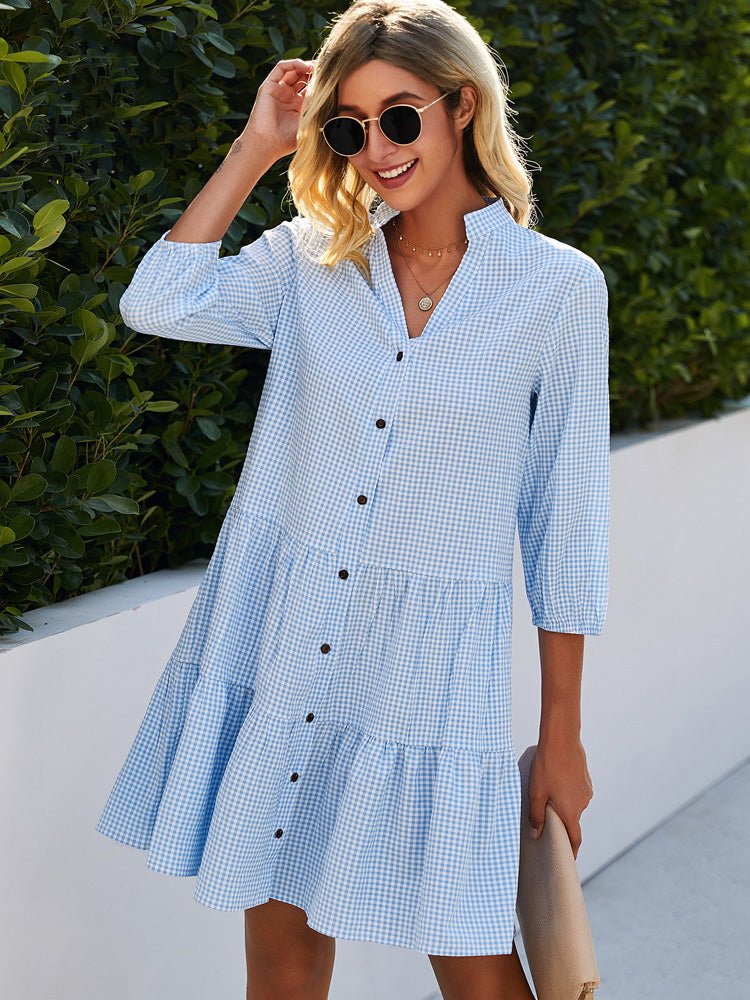 Woman wearing the Janet check-print day dress in blue, enjoying a morning walk.