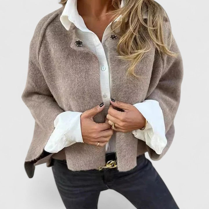 A woman wearing a relaxed open-front jacket over a blouse