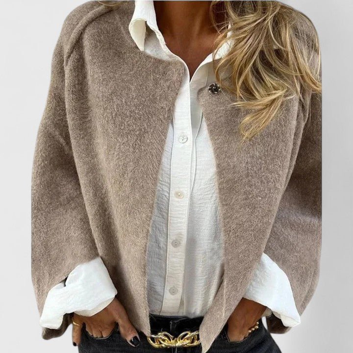 A woman wearing a relaxed open-front jacket over a blouse