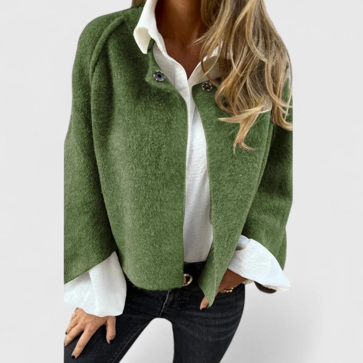 A woman wearing a relaxed open-front jacket over a blouse